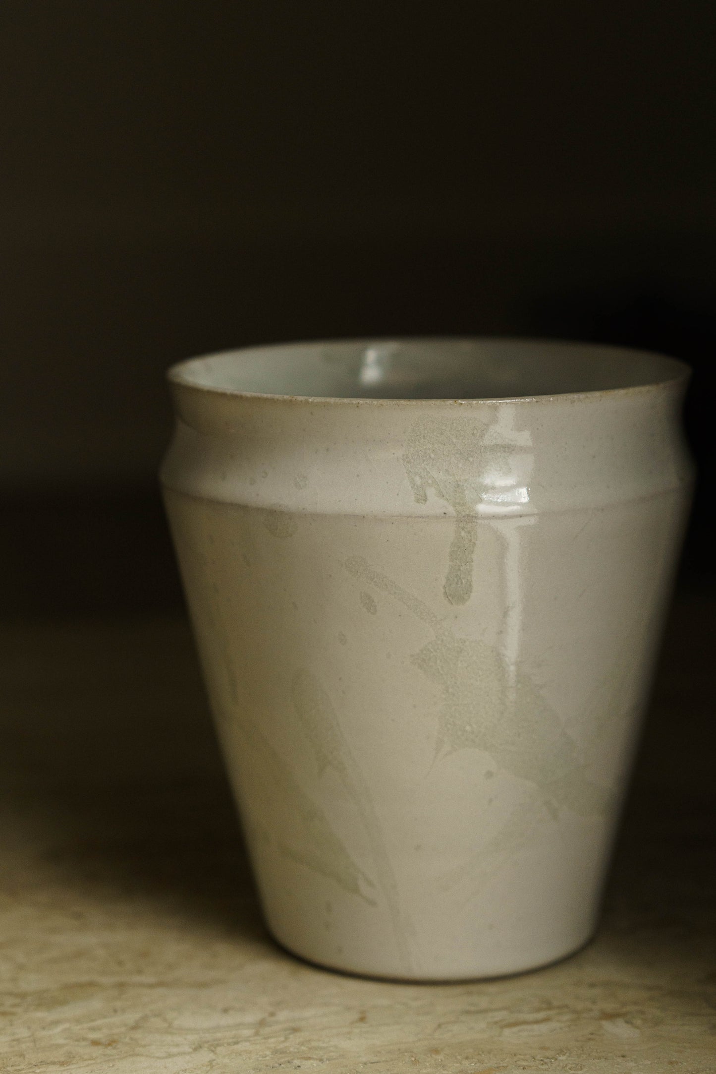 Tall straight walled vase with curved lip in white with transparent spatter.