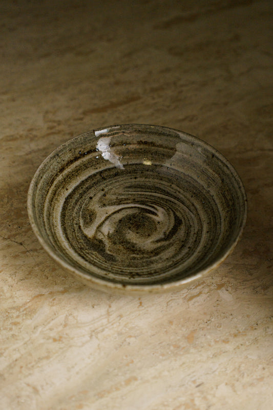 Ceramic bowl with swirls of dark and light clay