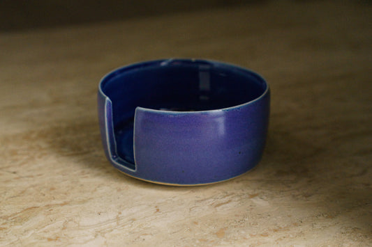 Blue ceramic pot with a notch on the wall