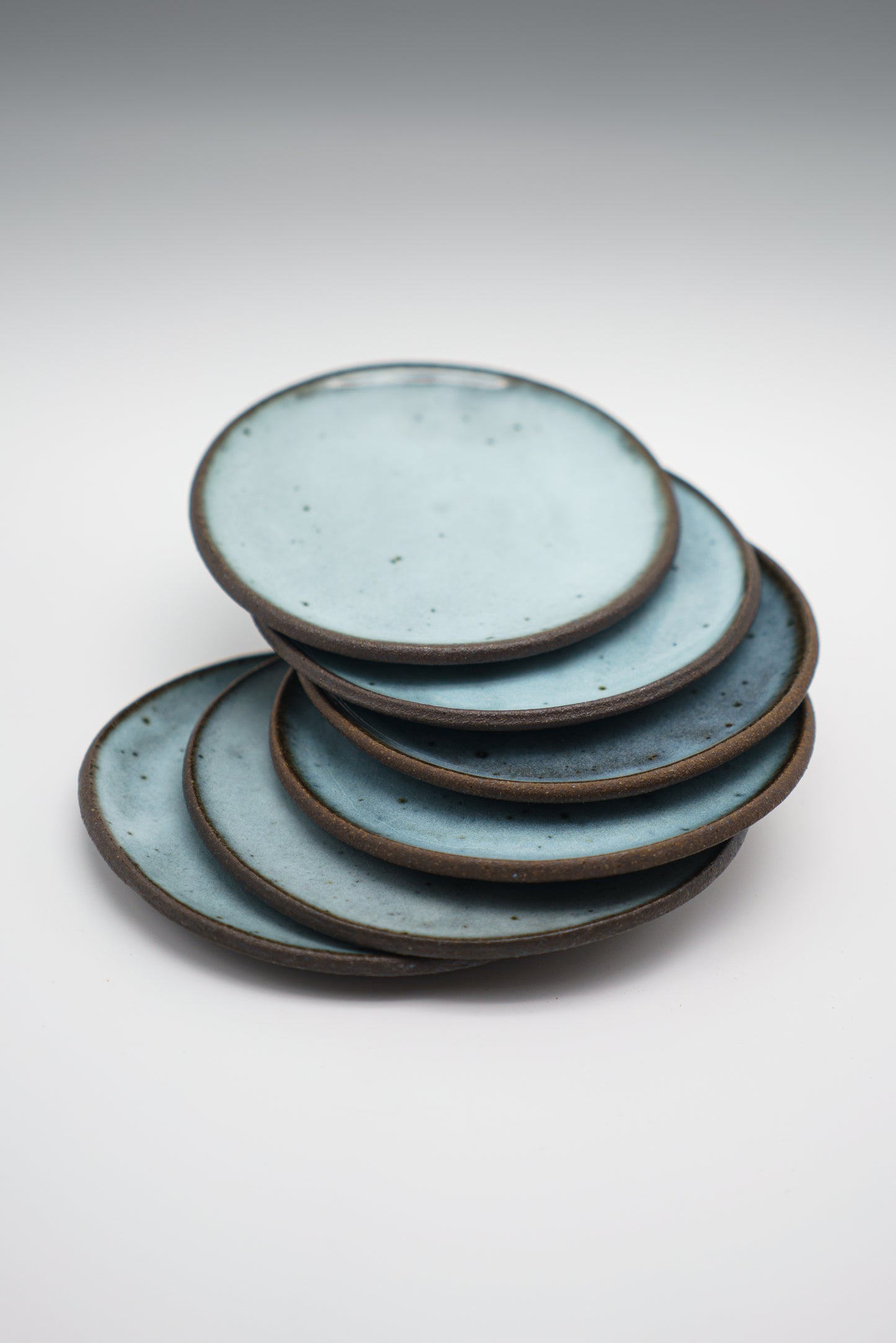 Icy Blue Plate Set on Dark Clay