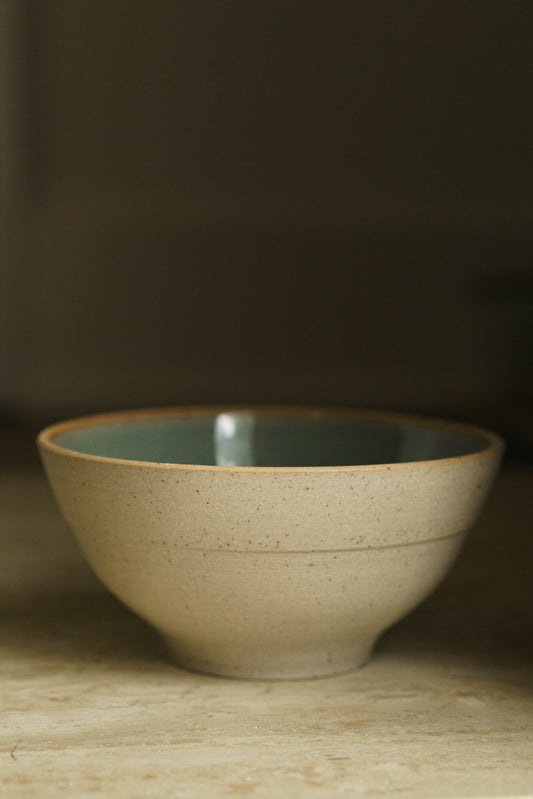 Bowl with ride on the unglazed outside wall and celadon glaze inside.