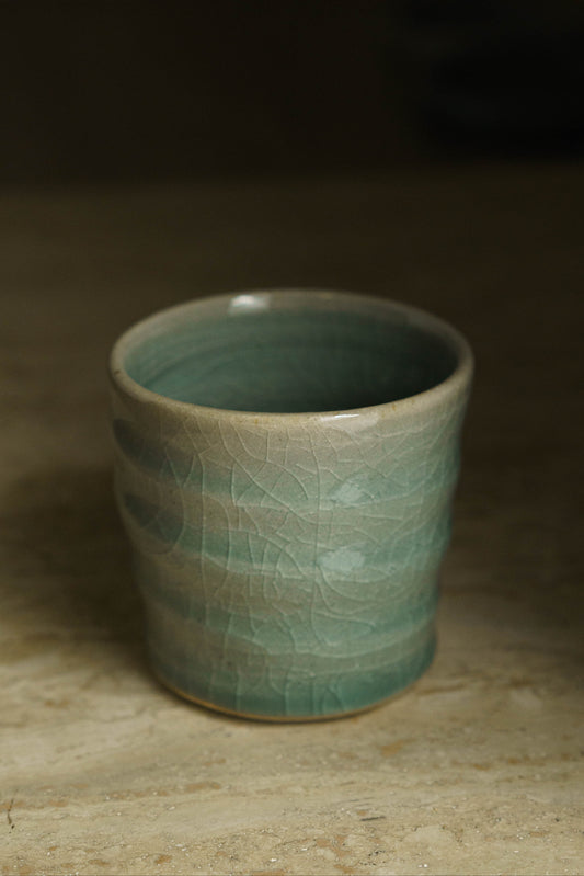 Cup with swirly ridges in celadon.