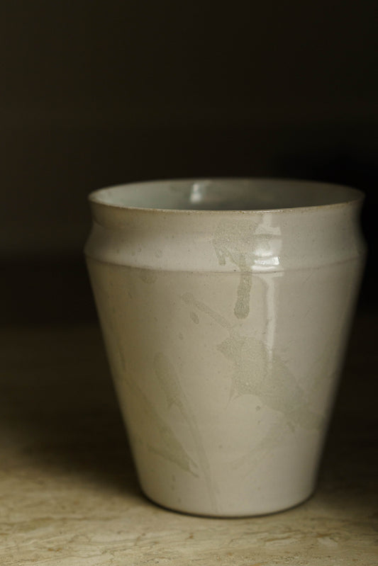 Tall straight walled vase with curved lip in white with transparent spatter.