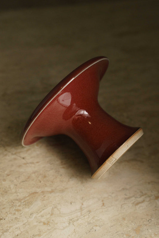 Cranberry red ceramic plate with a long pedestal