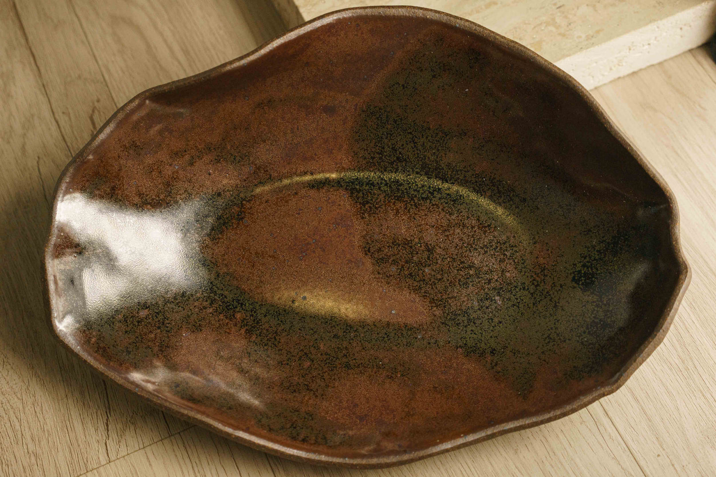 Large ceramic bowl with brown and black glaze