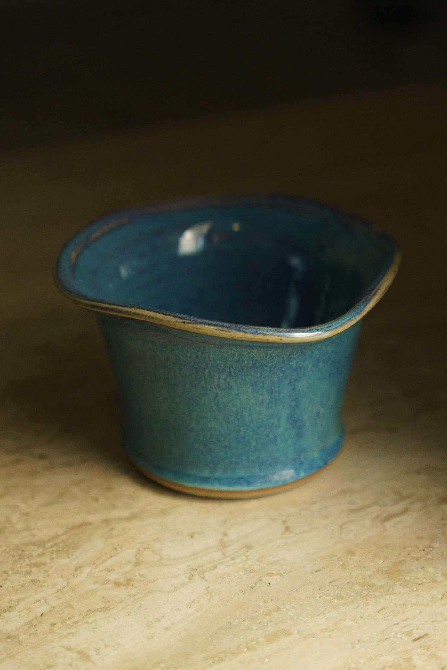 Blue ceramic flower pot with a rim that flares out
